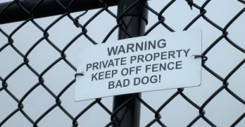 A high fence with a warning